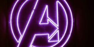 The Avengers logo in purple neon lights